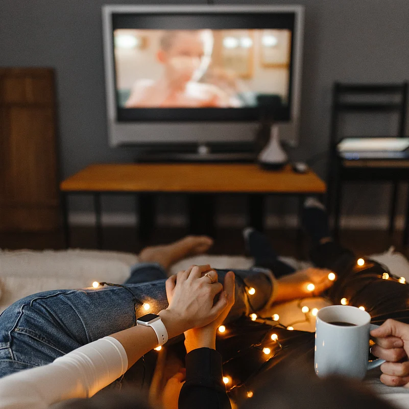 A couple watching television together