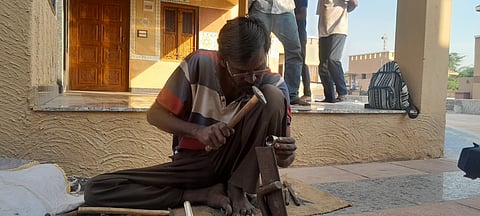 Nanji Maheshwari creating bell chimes at the Nirona Gram Hatt.