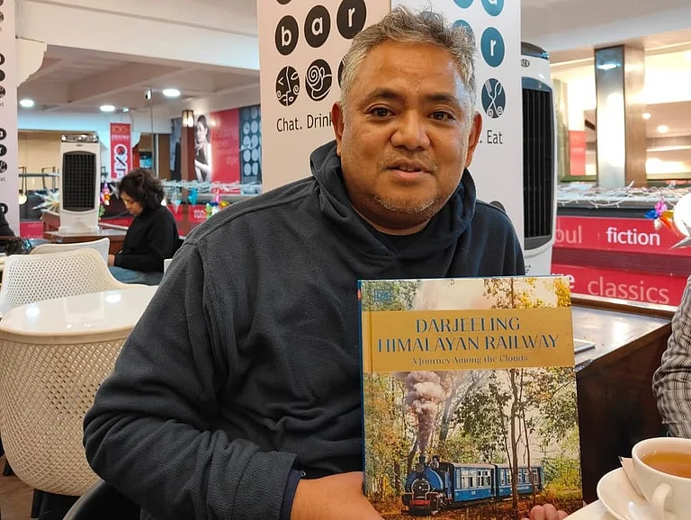 Rabindra Rai with a book on the
Darjeeling Himalayan Railway. - rabindra_art/Instagram