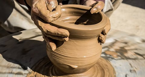 A potter at work in the Gufkral caves.