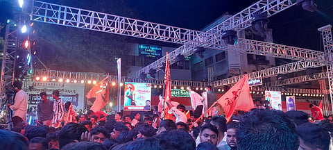 People in large numbers dancing at the pandal.