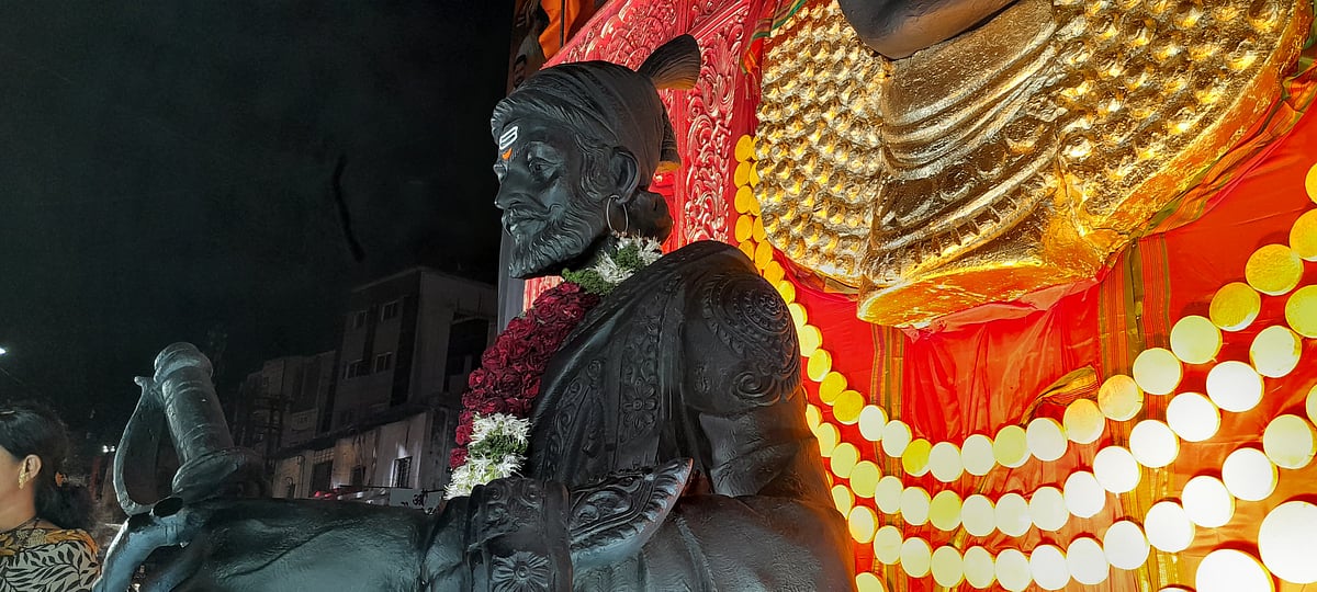 A grand statue of Shivaji Maharaj at a pandal. 