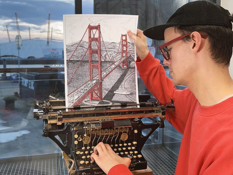 Cook with his artwork of the Golden Gate Bridge - James Cook