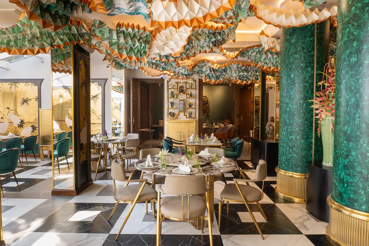 The hand-painted dancing dragons by Ankon Mitra on the ceiling add a festive touch