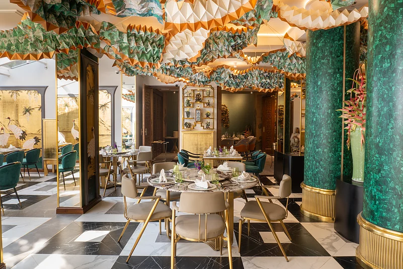 The hand-painted dancing dragons by Ankon Mitra on the ceiling add a festive touch