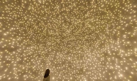 In "Massless Suns and Dark Suns," spheres of light and darkness converge to challenge perceptions of reality.