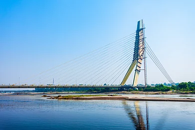 saiko3p/Shutterstock : The Signature Bridge spans the Yamuna River and connects Wazirabad to East Delhi