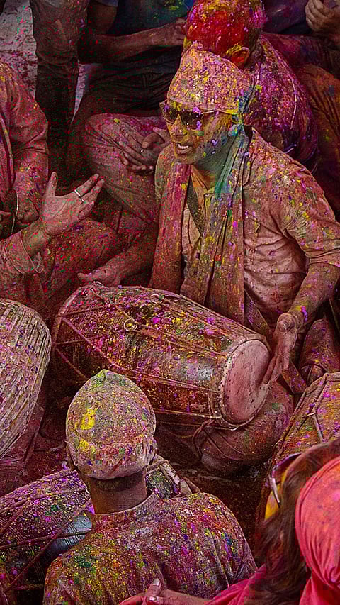 People sing and dance on Holi