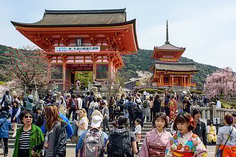 Tourists visit the Kiyomizu-dera, a Buddhist temple located in eastern Kyōto that is a UNESCO World Heritage Site