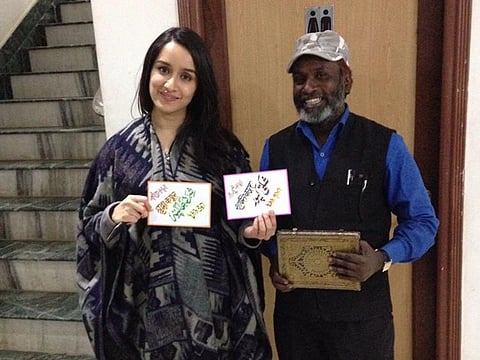 Ansari with actor Shraddha Kapoor, who is holding a handpainted postcard gifted by him