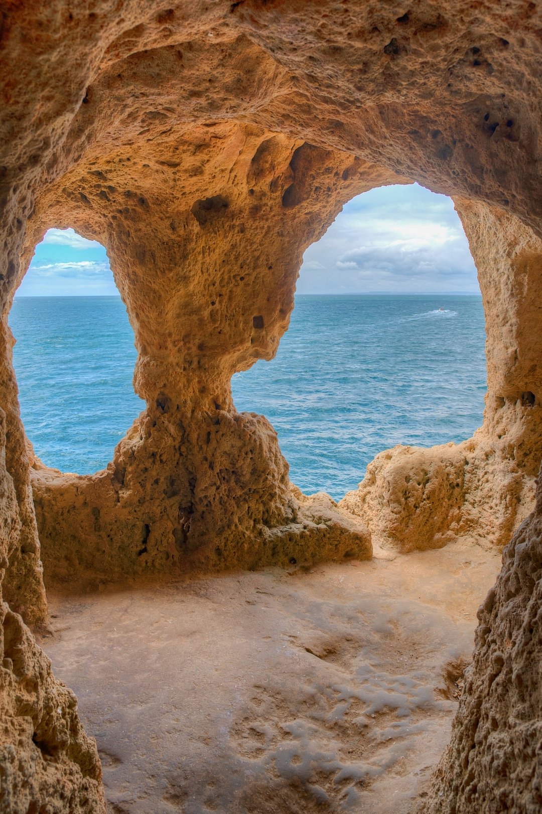 Coastline of cliffs, caves, and rock pools near Carvoeiro in The Algarve