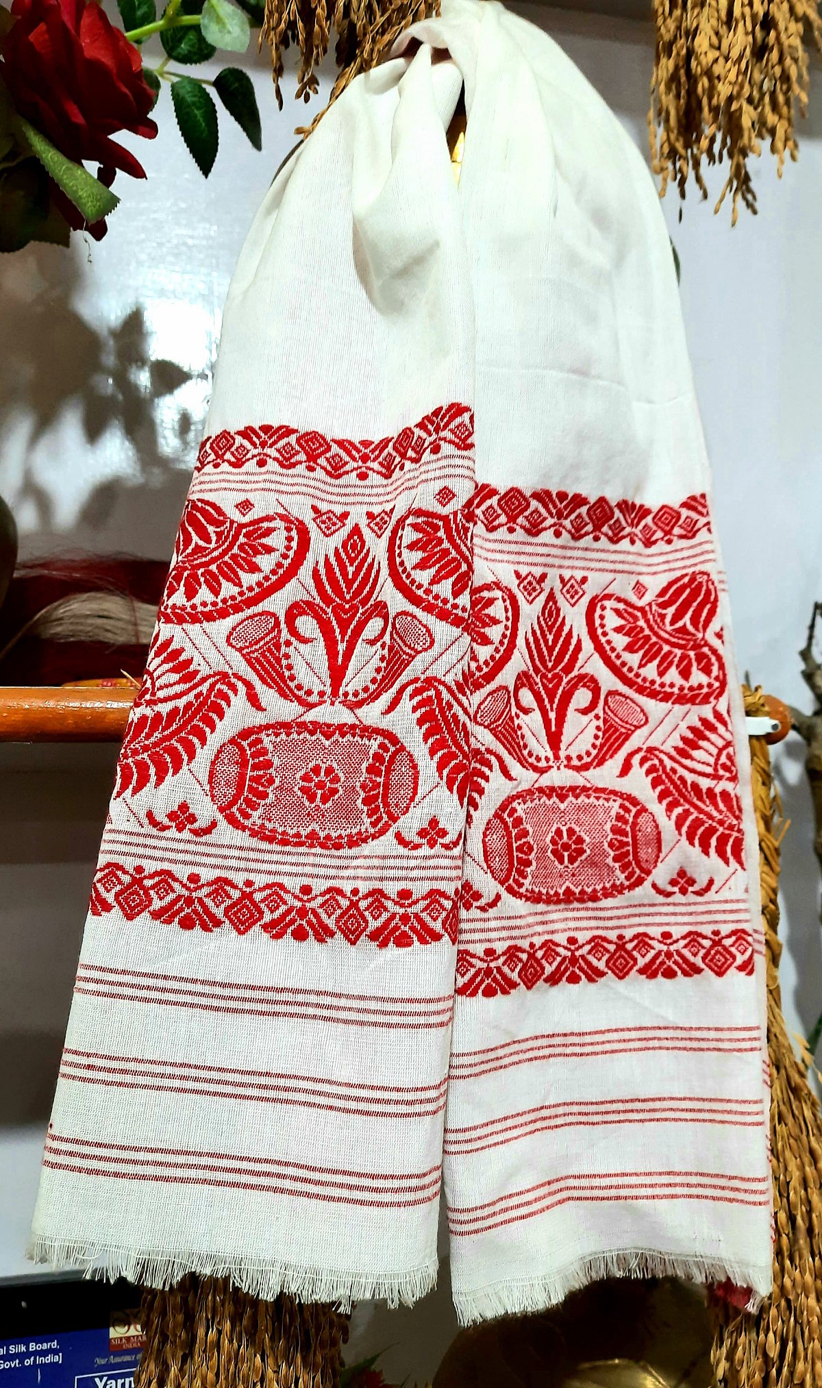 The traditional Gamusa of Assam is worn as a symbol of cultural pride. 