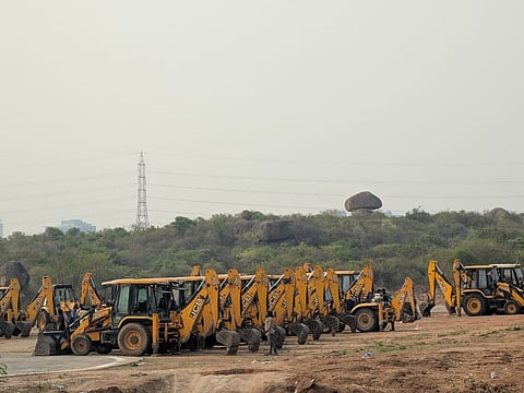 Bulldozers prepare to cut down trees in the Kancha Gachibowli forest