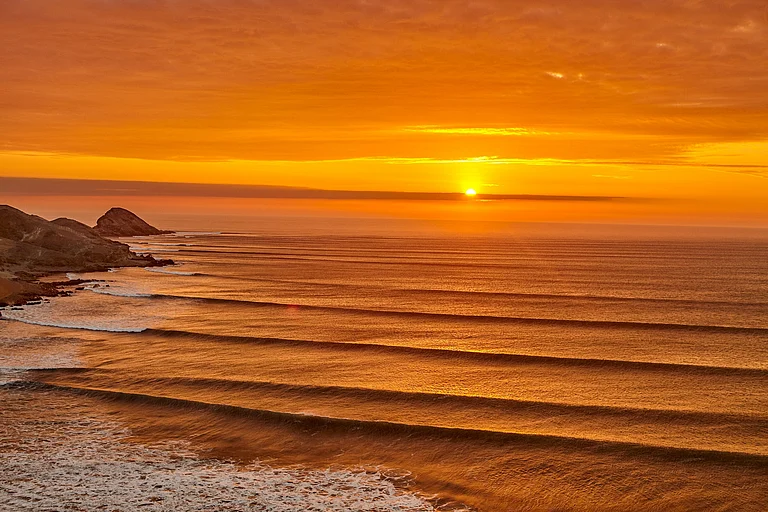 The Chicama waves roll up to the fishing town of Puerto Malabrigo in northern Peru - BETO SANTILLAN/Shutterstock