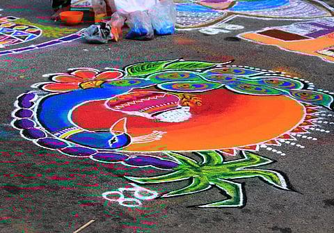 Colourful and intricate floor art called kolam is created using rice powder in front of houses during Puthandu