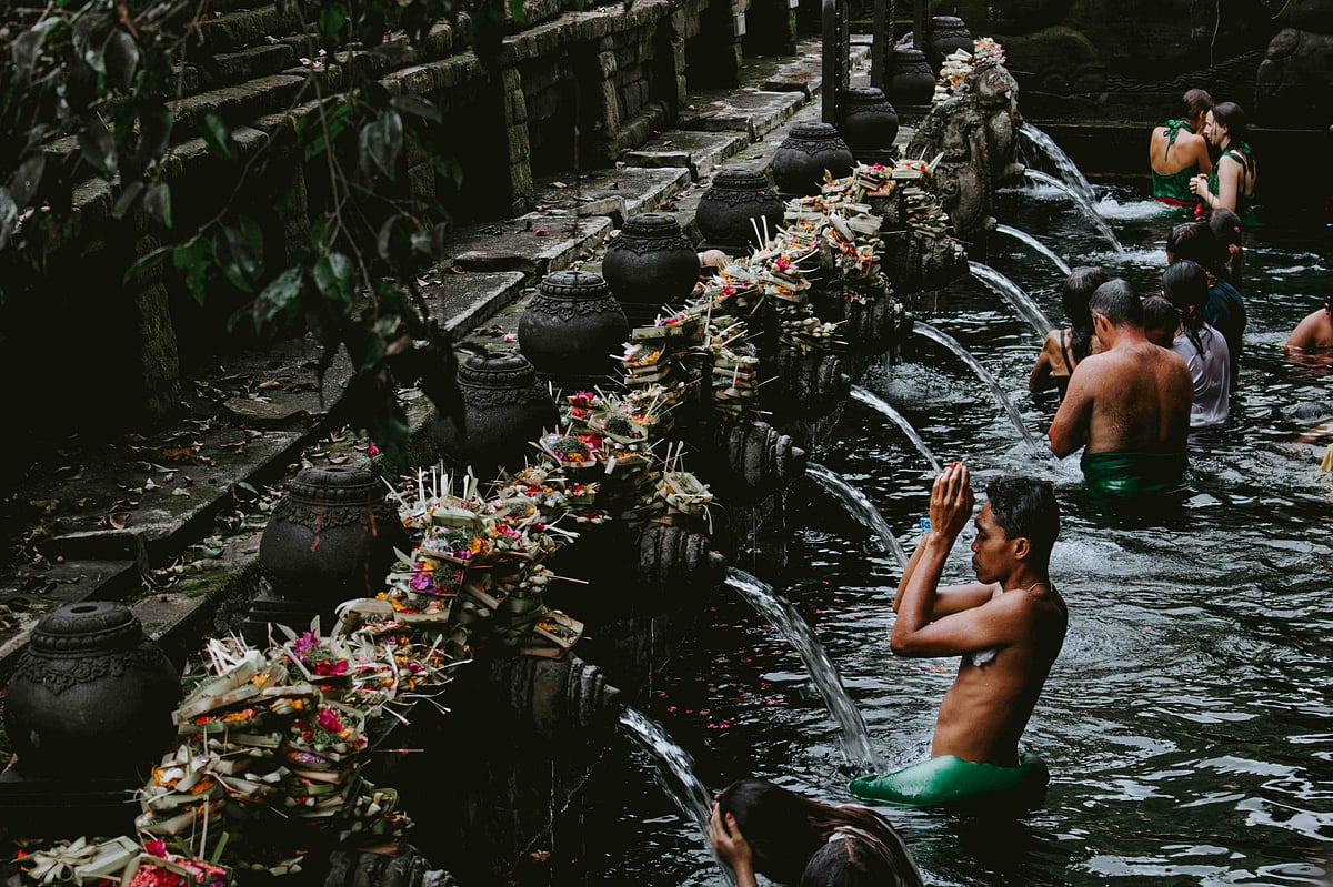 Locals participating in traditional purification rituals at Pura Tirta Empul in Bali.