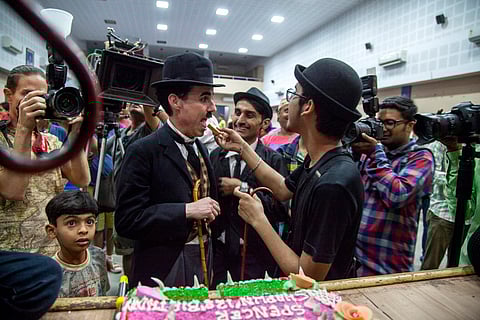 Charlie Circle members in Adipur eat cake on Charlie Chaplin's birthday (April 16)