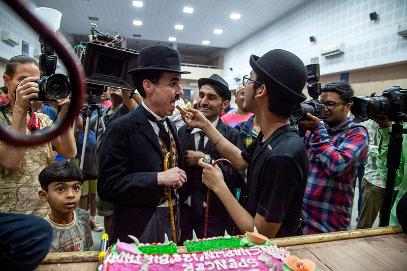 Charlie Circle members in Adipur eat cake on Charlie Chaplins birthday (April 16)