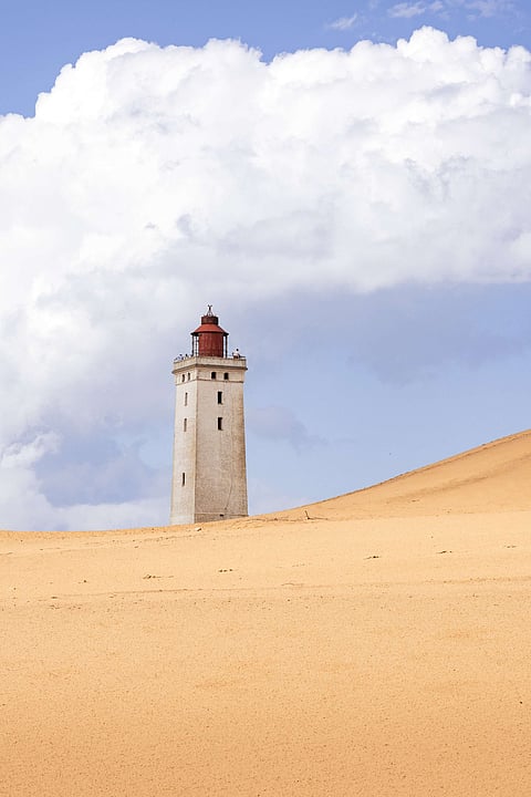 The Rubjerg Knude appears to rise out of the Råbjerg Mile