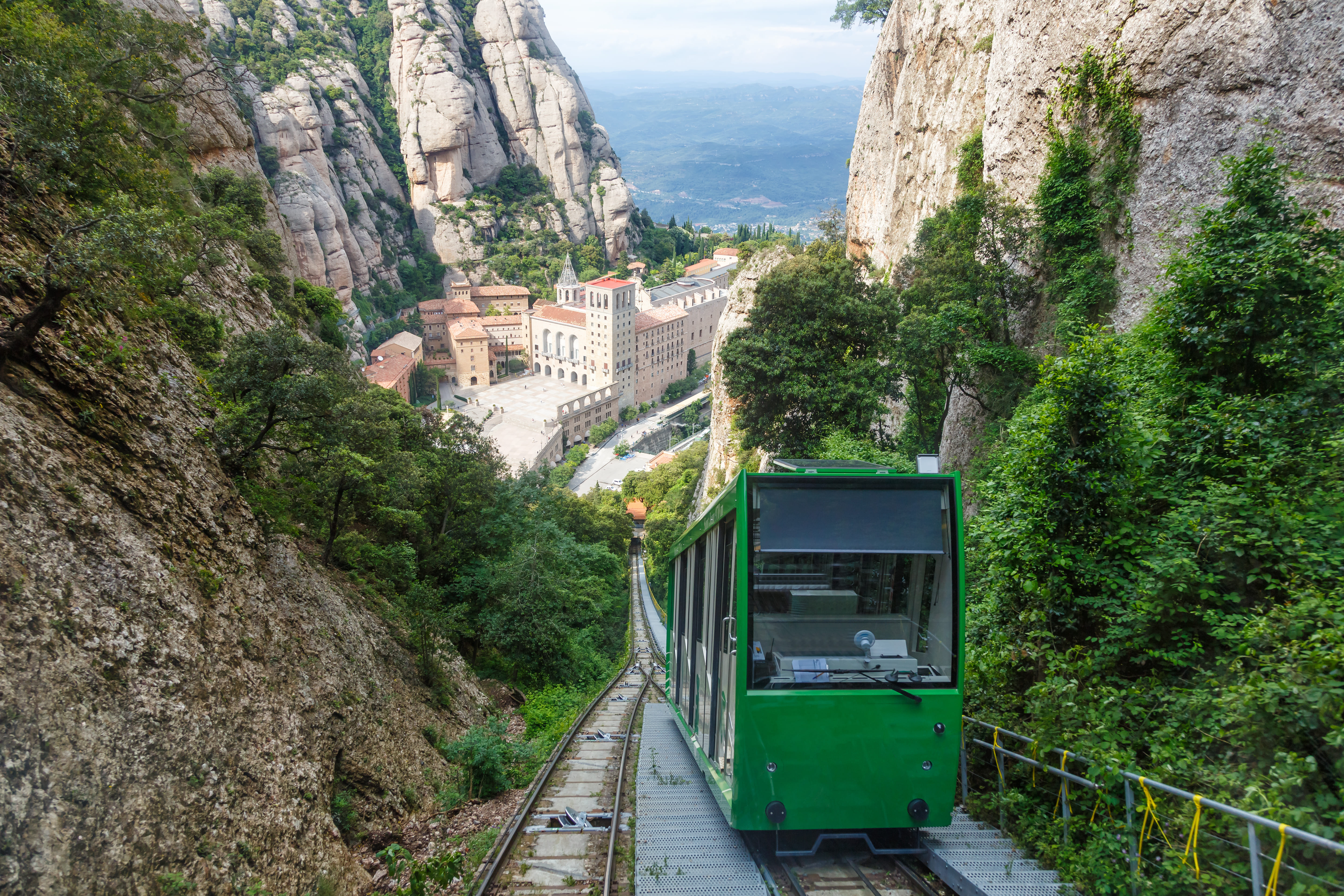 The Montserrat funicular railway passing through rocky landscapes and greenery