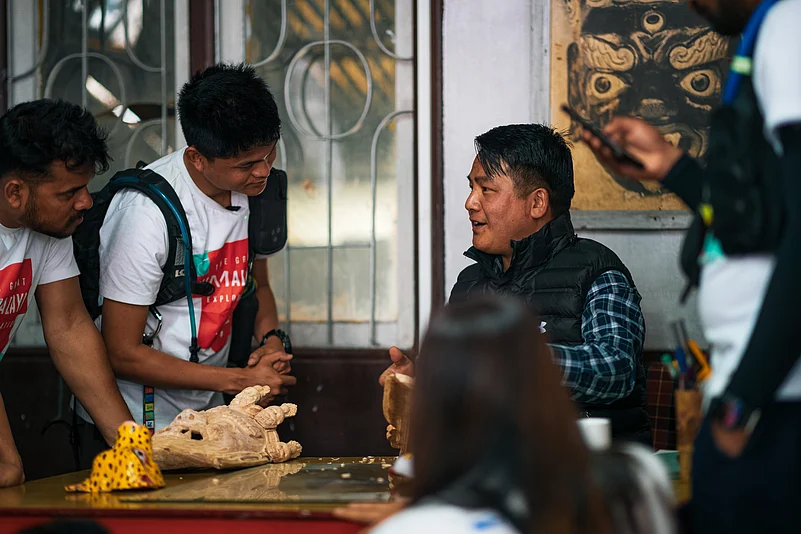 Karma Lepcha (right) has been carving masks since he was 17