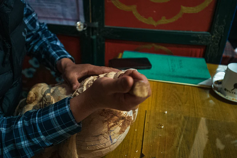 The masks are typically carved from a durable, lightweight wood known locally as Zaru Shing