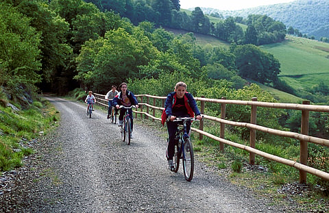 Tourists cycling along one of Spain's scenic green natural trail