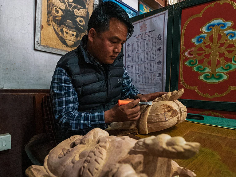A mask maker in Gangtok, Sikkim at work - Royal Enfield Social Mission