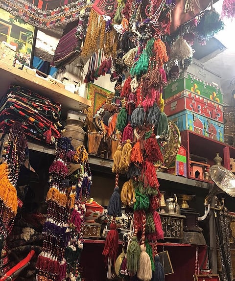 A shop in Souk Al-Zal  selling traditional rugs, bisht, swords, bakhour, and outfits