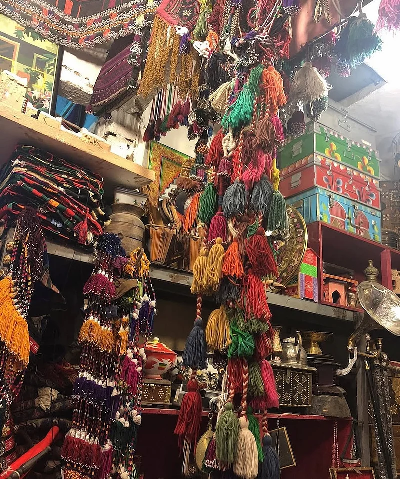A shop in Souk Al-Zal selling traditional rugs, bisht, swords, bakhour, and outfits