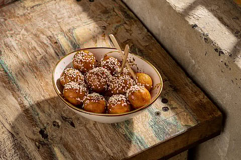 Luqaimat is a fried dumpling typically coated in date syrup or honey
