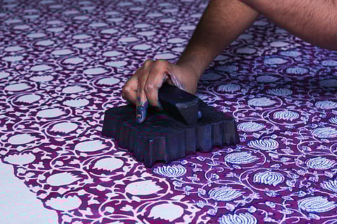 An artisan at work on hand-block printing