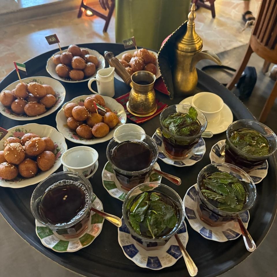A platter comprising Luqaimat (Arabic doughnut balls) and herbal tea