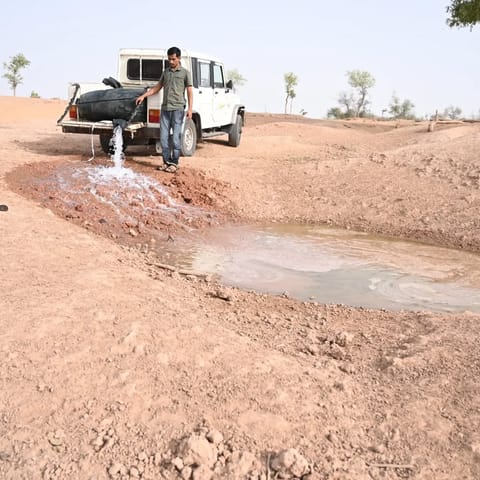 Radheshyam Bishnoi refills a water hole in Desert National Park