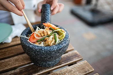 Creative Family/Shutterstock : Som tum is a papaya salad, a popular street snack in Bangkok