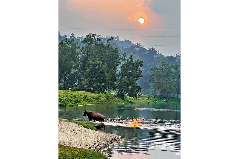 A winding river flowed through rolling meadows