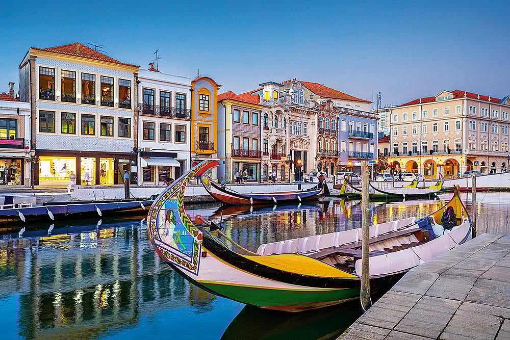 Courtesy: Centre of Portugal : Aveiros canals are renowned for their moliceiro boats, which are bursting with colour
