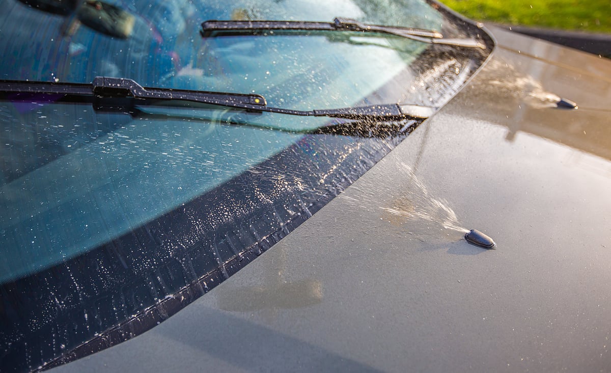 Top up your windshield wiper and washer fluid prior to a road trip in the monsoon