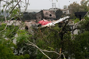 AP Photo/Rafiq Maqbool : Parts of the Air India plane that crashed on Thursday seen on top of a building in Ahmedabad