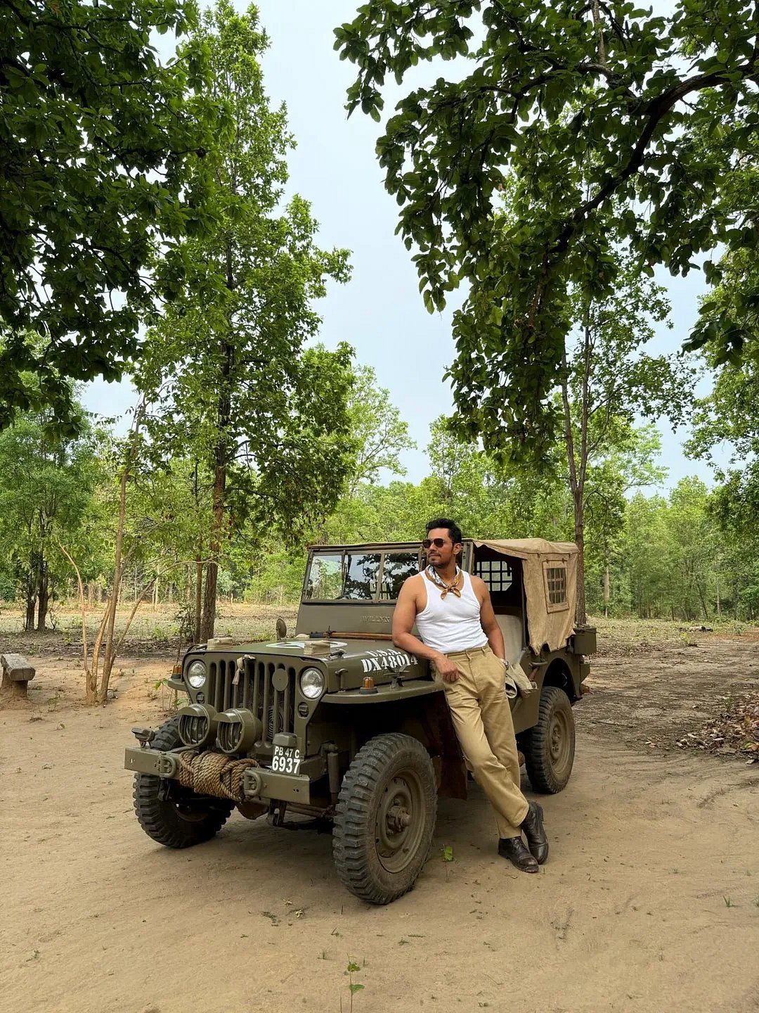 Hood poses by a safari jeep in Kanha