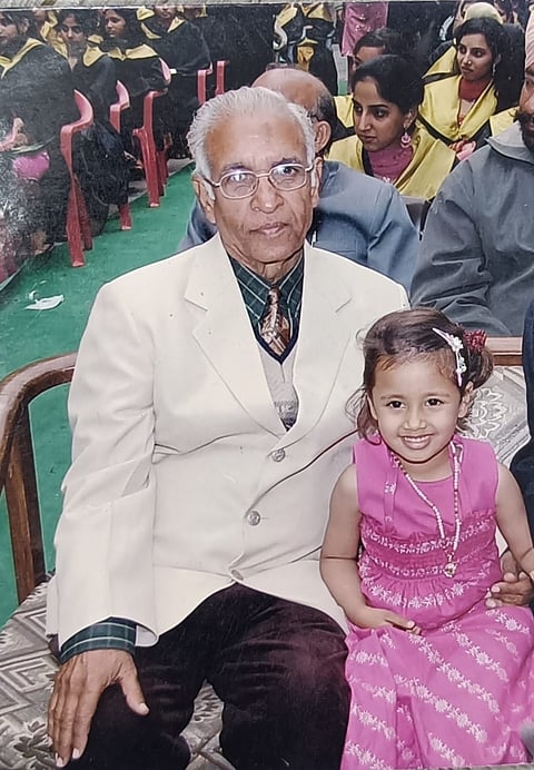 Rahat Sharma and her grandfather at a school event