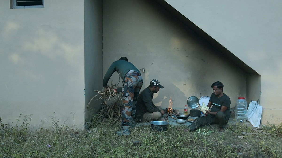 Babban (right) prepare a meal with their colleagues