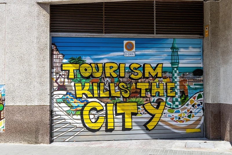 A spray painted message against overtourism in Barcelona, Spain
