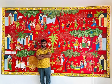 Vinay Kumar : Vinay Kumar with one of his Cheriyal art paintings. This one showcases rural life in Telangana