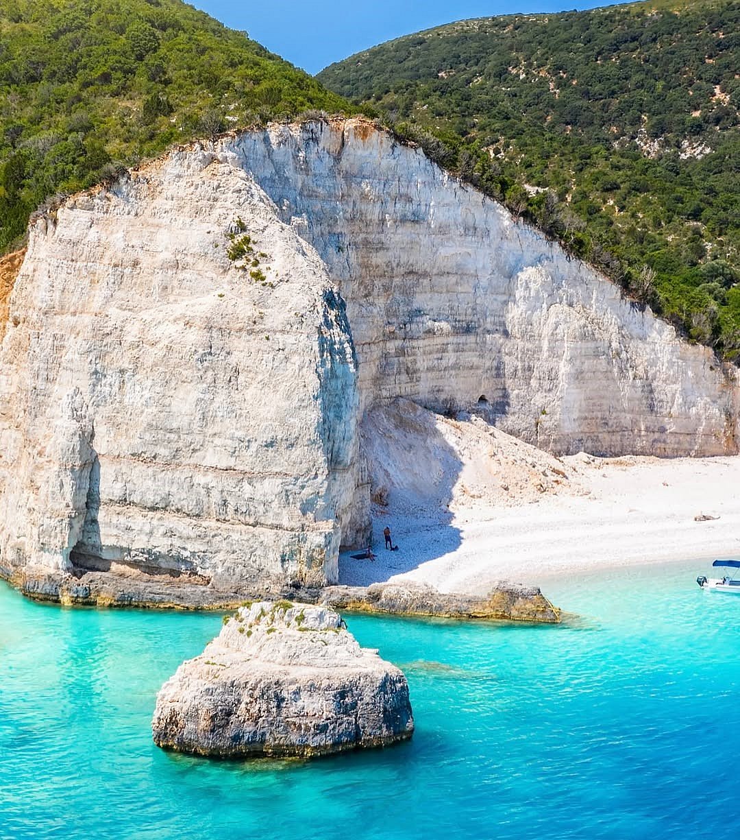The dramatic white cliffs of Fteri Beach in Greece
