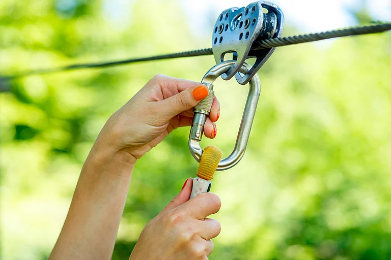 The safety hook of a zipline - RossHelen/Shutterstock