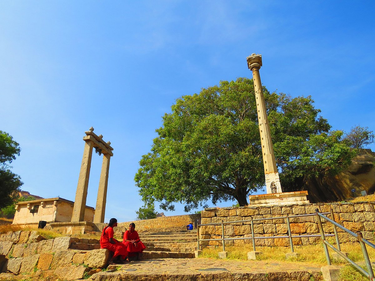 A timeless scene—two women converse near the stambha of the Eknatheshvari Temple inside Chitradurga Fort
