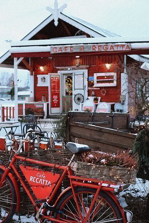 The café is located in a small red cottage by the sea
