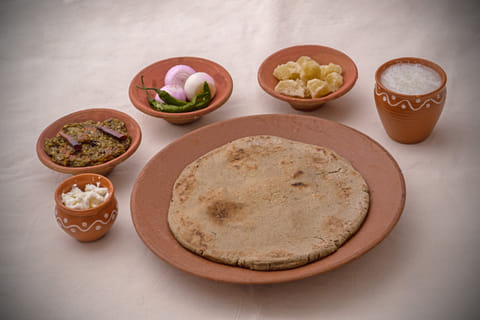 Bajra rotlas with jaggery and buttermilk.