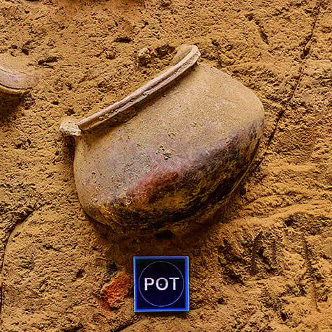 This embedded pot discovered in situ was likely used for grain storage within a residential unit. Such features demonstrate how architecture integrated everyday utility and storage